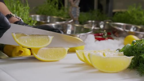 Chef Slicing Fresh Lemons in Commercial Kitchen