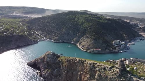 Aerial View of Jagged Cliffs Overlooking Calm Bay
