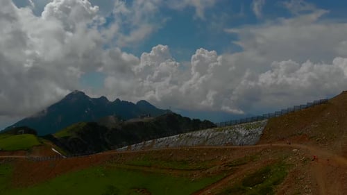 Aerial Video Shooting of a Deserted Hilly Area. a High Mountain Is Visible on the Horizon. the Sky