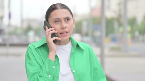 Angry Hispanic Woman Talking on Phone Outdoor