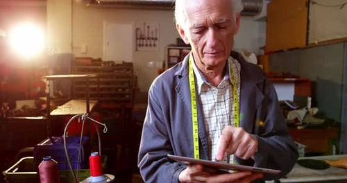 Schuhmacher nutzt digitales Tablet
