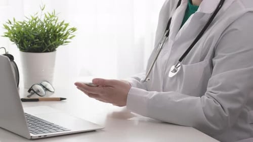 Doctor Working with Tablet Device in Office