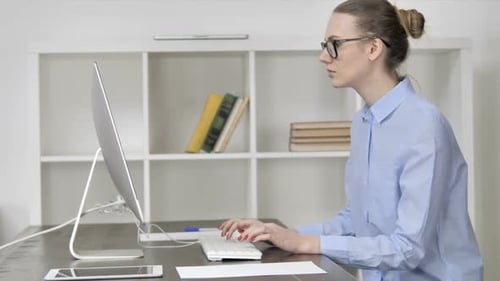 Young Casual Girl Working On Computer in Office