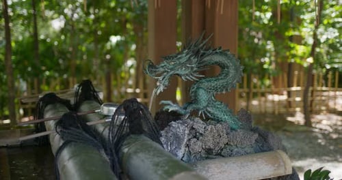 Woman wash hand before enter Japanese temple