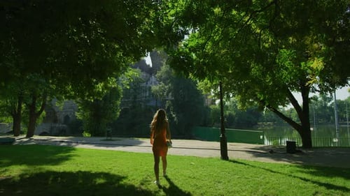 Woman walking towards Vajdahunyad Castle