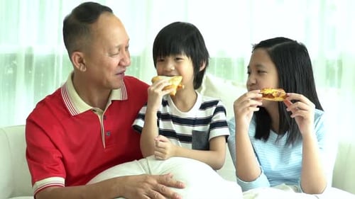 Family Enjoying Pizza Together at Home
