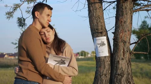 Man Hugs Girlfriend Near Poster of Missing Cat in Park
