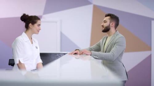 Happy Man Taking Patient Registration Form at Hospital Reception