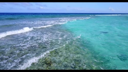 Aerial flying over travel of tropical seashore beach voyage by blue sea and white sandy background o