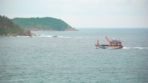 Lokales Motorboot schwimmt langsam auf ruhigen Wellen durch die Meeresbucht