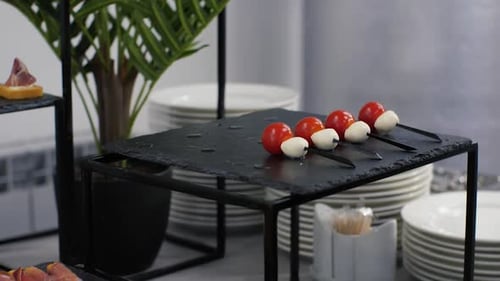 Attractive Food Display with Skewers and Prosciutto