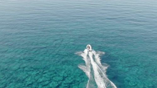 Motorboat Speeding Across Turquoise Ocean Waters