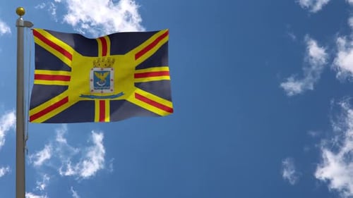 Waving City Flag with Emblem Against Blue Sky