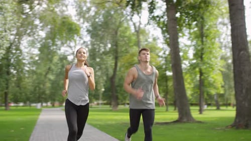 Athletic Couple Jogging in Park