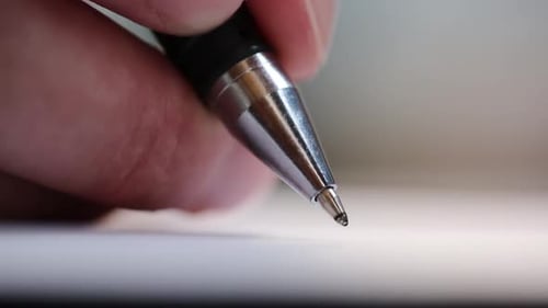 Man Signs With A Ballpoint Pen On A White Sheet Of Paper. Important Records. Office Work. Macro View