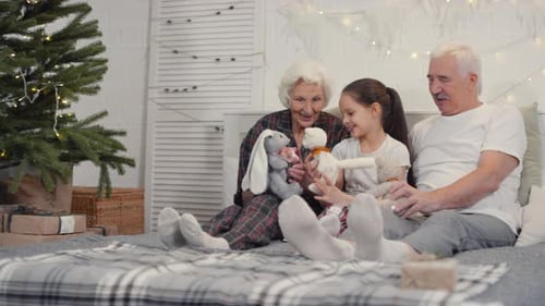 Loving Family on Bed With Christmas Gifts