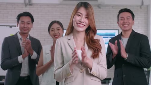 Cheerful Team Clapping in a Modern Workplace