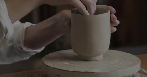 Hands Shaping Clay Pot on Pottery Wheel