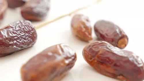 Date palm fruitexotic fruit on white background slow tilting 4K 2160p UltraHD footage - Phoenix dac