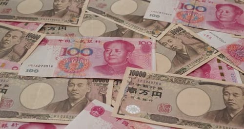 Pile of Japanese Yen and Chinese Yuan Currency