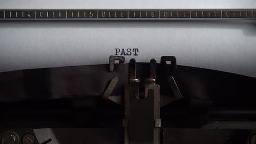 Typing word Past on a vintage typewriter. Close up.