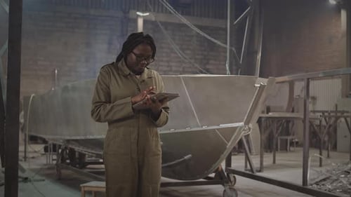 Female Engineer Taking Notes in Dockyard