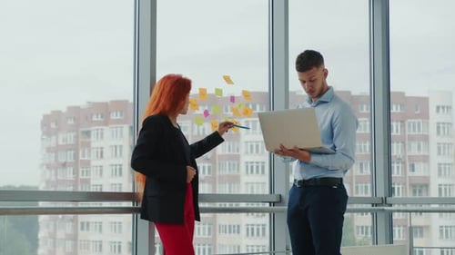 Young Professionals Collaborating on Project in Modern Office