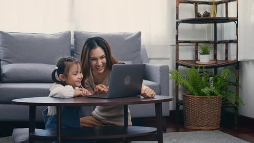 Mother and Daughter Using Laptop at Home