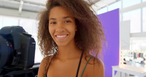 Model holding camera in photo studio 4k