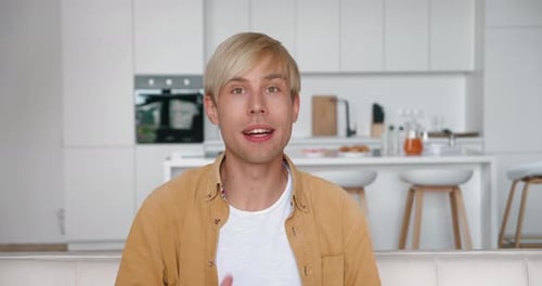 Young Adult with Blonde Hair Speaking Indoors