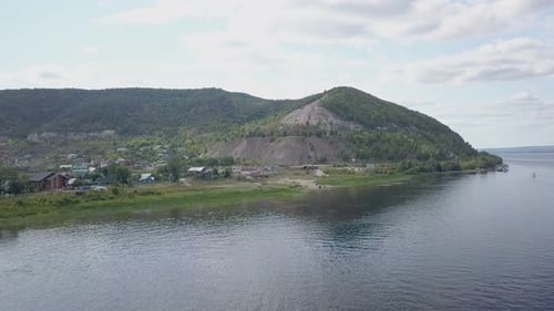 Drone Is Flying Over River and Moving To Coast with Mountains in Summer Day, Aerial
