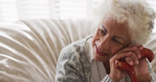 Senior Woman Smiling and Leaning on Cane