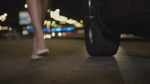 Female Legs in High Heels Walk on Roadside at Dusk