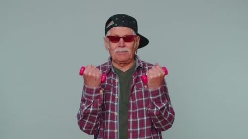Active Senior Man Working Out with Dumbbells