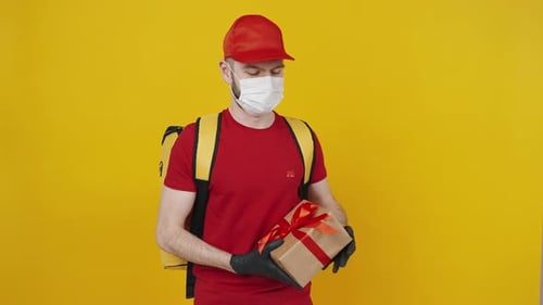 Delivery Man Presents Wrapped Gift Box