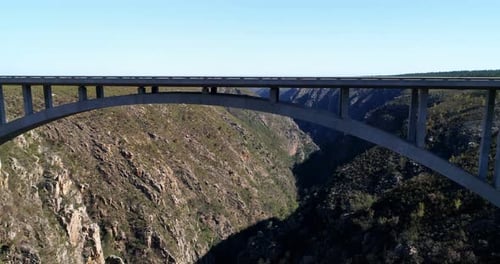 Vehicles moving on the bridge between the mountains 4k