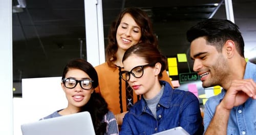 Team Collaborates Using Technology in a Modern Office