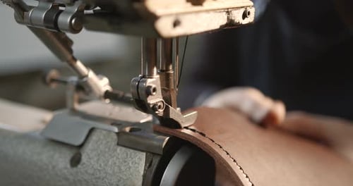 Craftsman Working with Leather in a Workshop