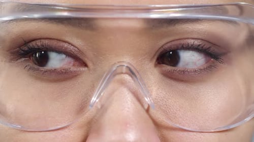 Close Up of Woman with Safety Goggles Blinking