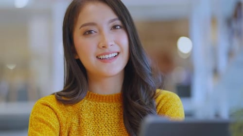 Smiling Woman with Tablet in Modern Workplace