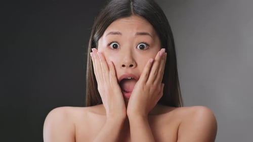 Portrait of Young Amazed Asian Woman Feeling Shock and Disbelief Opening Mouth and Touching Her