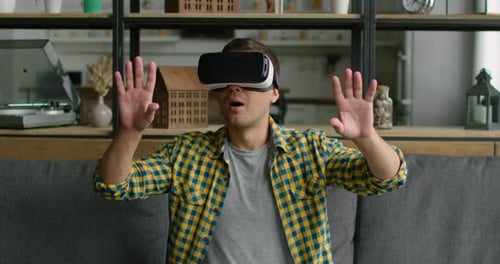 Man Experiencing Virtual Reality Headset at Home