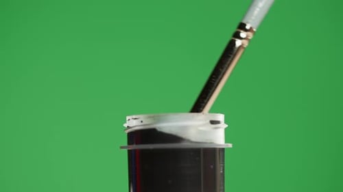 Black Paint Isolated on Green Background