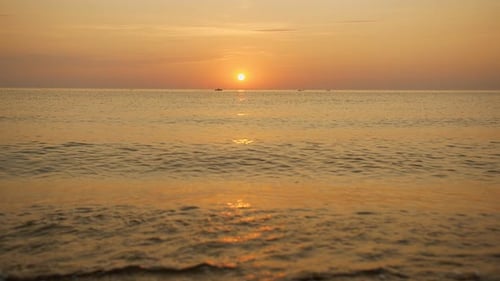 Golden Sunset Over Calm Beach Waters