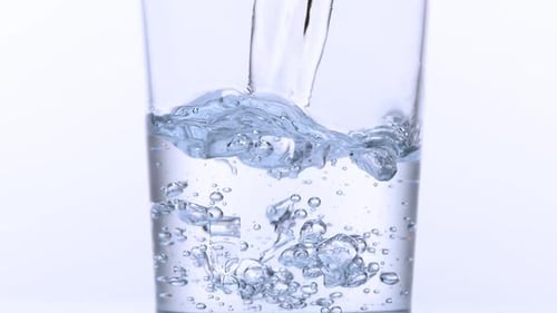 Water Pouring Into a Glass with Bubbles