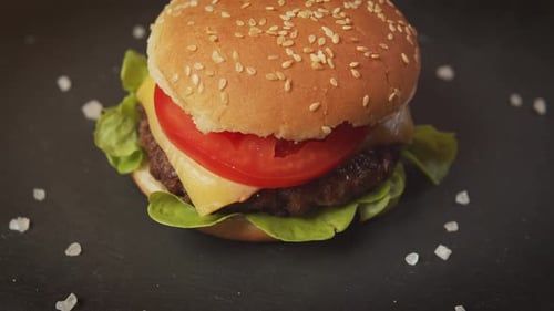 Delicious Cheeseburger with Lettuce, Tomato, and Sesame Bun