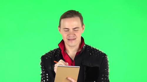 Guy Happy Writes with Pencil in Notebook. Green Screen