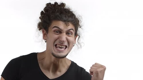 Man Expressing Intense Emotions and Clenching Fist