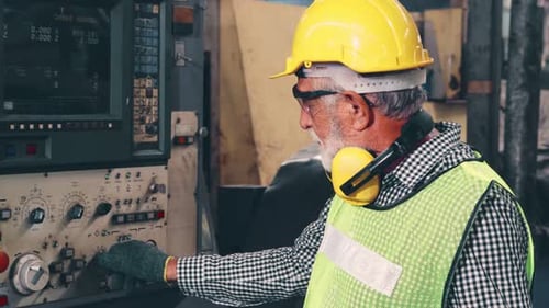 Senior Factory Worker Teach How to Use Machine Equipment in the Factory Workshop