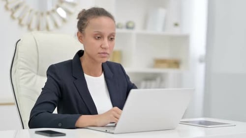 Professional African Businesswoman Doing Video Call on Laptop in Office
